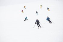 Skiers coming down slope, selective focus — Stock Photo