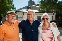 Portrait of seniors standing together and smiling at camera — Stock Photo