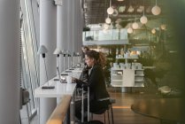 Woman using laptop in airport, selective focus — Stock Photo