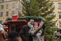 Paar macht Selfie auf Weihnachtsmarkt — Stockfoto