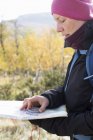Woman using compass and map, selective focus — Stock Photo