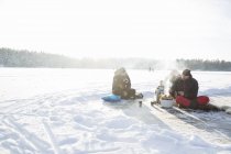 Boy and men with barbecue on frozen Drang lake in Uppland, Sweden — Stock Photo