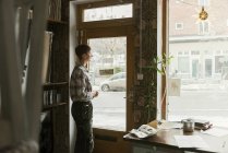Young woman by door, selective focus — Stock Photo