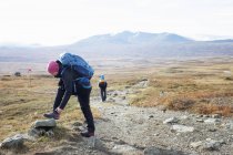 Woman fixing shoe during hike, selective focus — Stock Photo