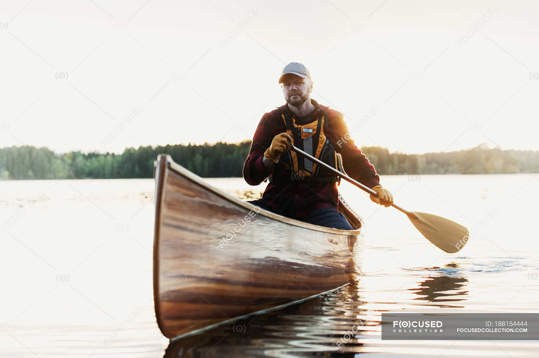 Man Paddling Canoe On Lake Wood Material Rowing Stock Photo   Focused 188154444 Stock Photo Man Paddling Canoe Lake 