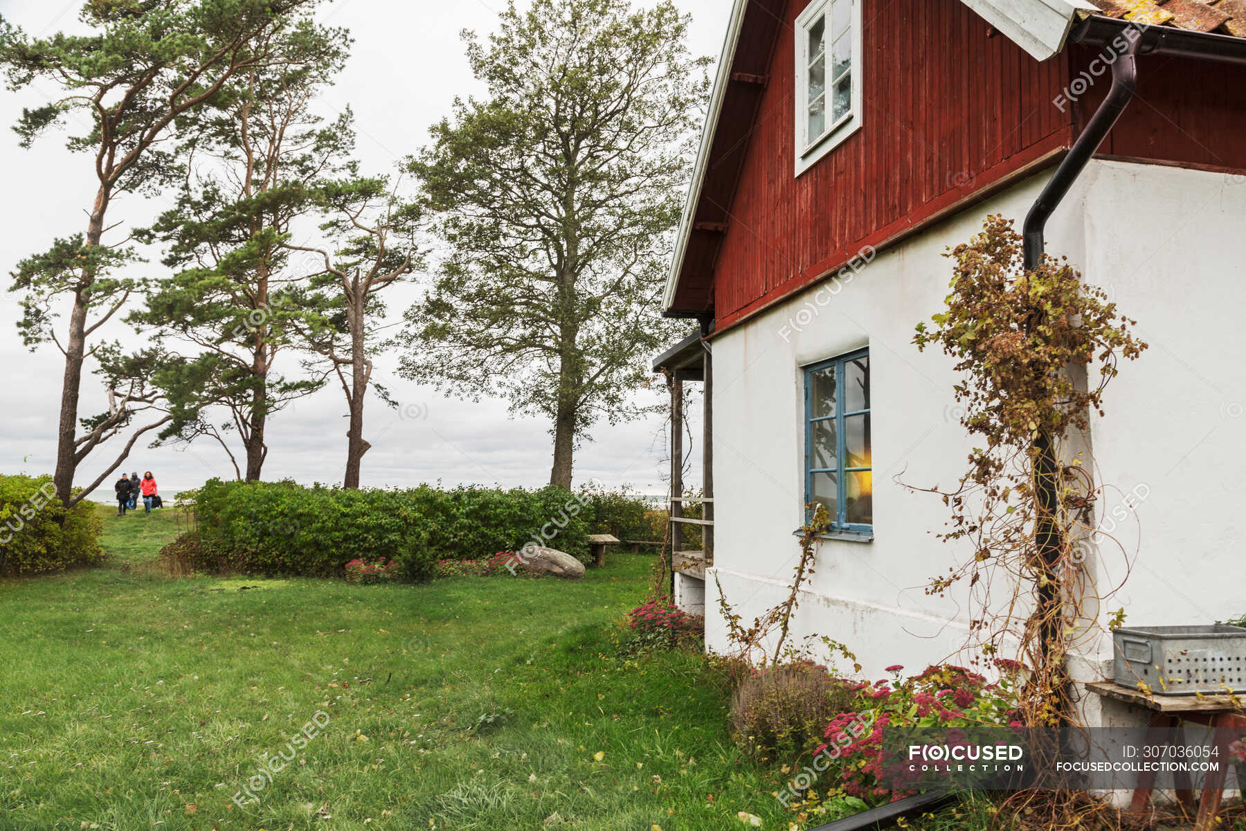 Side view of white house in countryside — Building Exterior, women