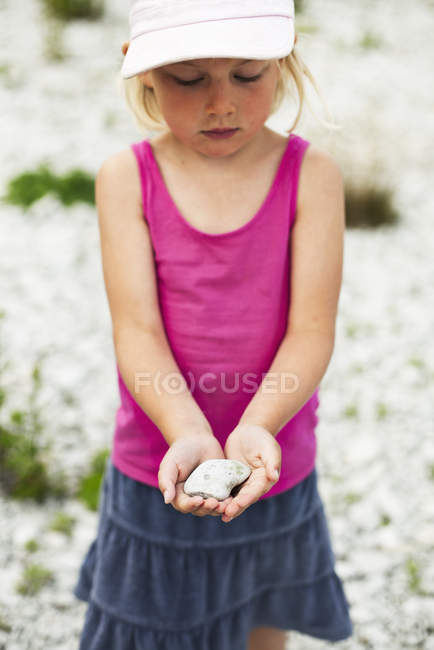 Girl holding rock, selective focus — Stock Photo