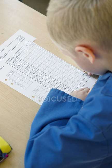 View of schoolboy writing, selective focus — Stock Photo