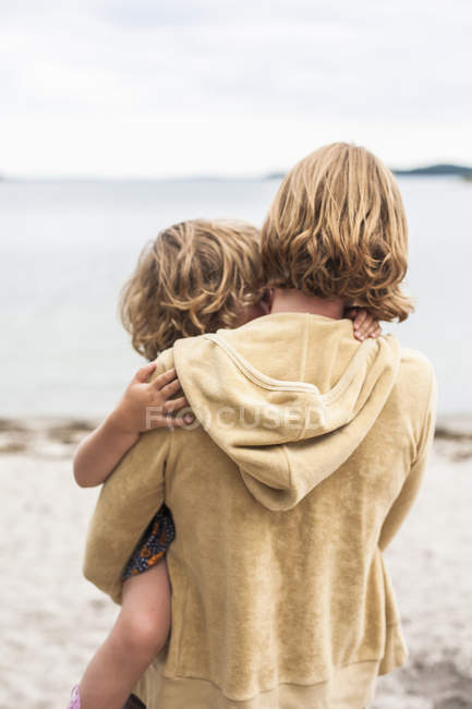 Back view of mother holding daughter — Stock Photo