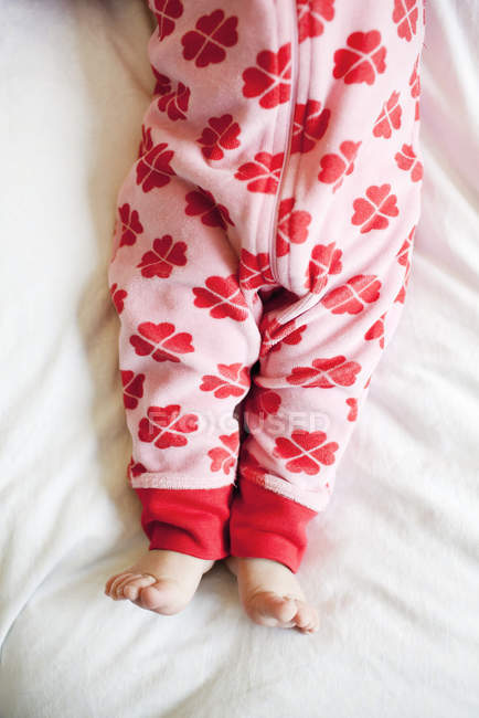 Low section of baby wearing red romper — Stock Photo