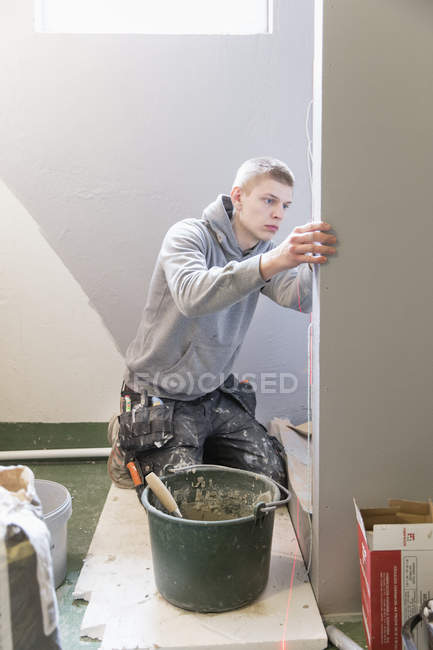 Man tiling walls, selective focus — Stock Photo