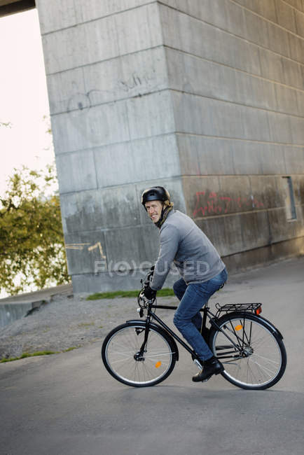 Вид збоку чоловіка їзда на велосипеді, фокус на передньому плані — стокове фото