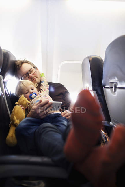 Father and daughter sleeping on plane, selective focus — Stock Photo