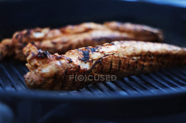 Close up shot of meat roasting on grill — Stock Photo