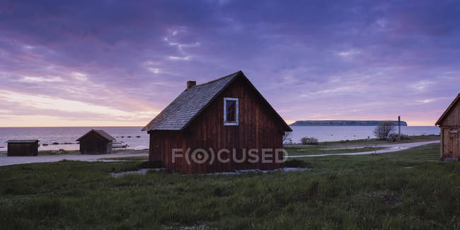 Wooden houses on seashore during dusk — Stock Photo