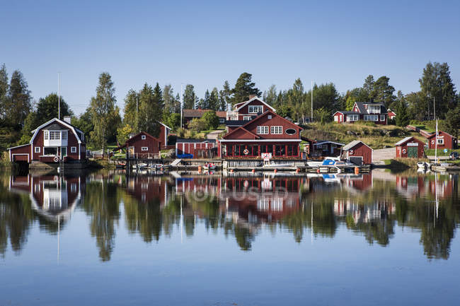Vista del pueblo pesquero falu edificios rojos en la orilla del río - foto de stock