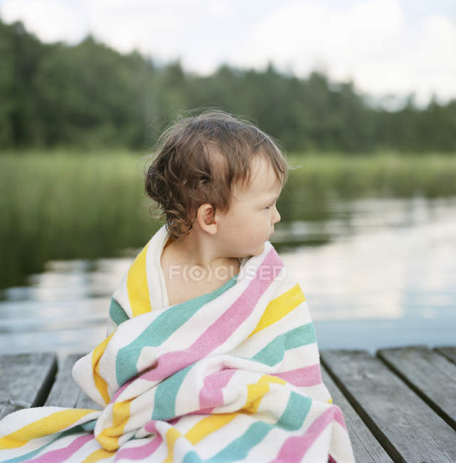 Portrait of girl wrapped in towel, focus on foreground — Stock Photo