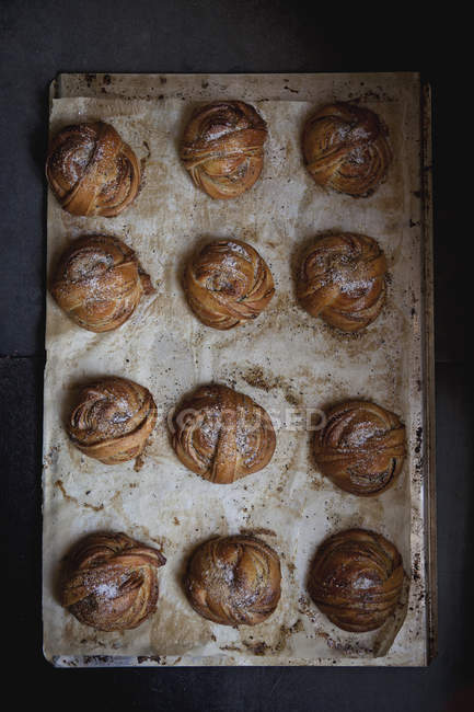 Top view of table with fresh baked cardamon buns — Stock Photo