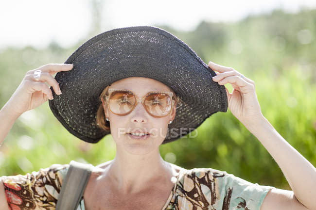 Portrait of mature woman in black hat — Stock Photo