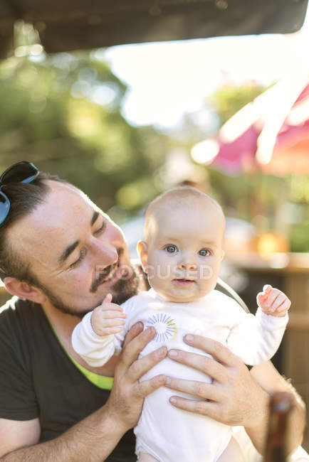Portrait of baby boy with father, focus on foreground — Stock Photo
