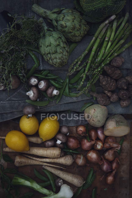 Variety of vegetables, mushrooms and lemons, top view — Stock Photo