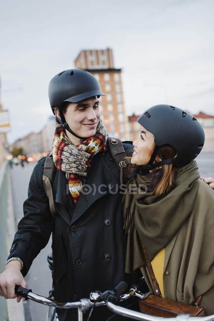 Young couple with bicycles on street, focus on foreground — Stock Photo