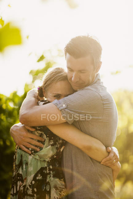Portrait of mature couple embracing, focus on foreground — Stock Photo