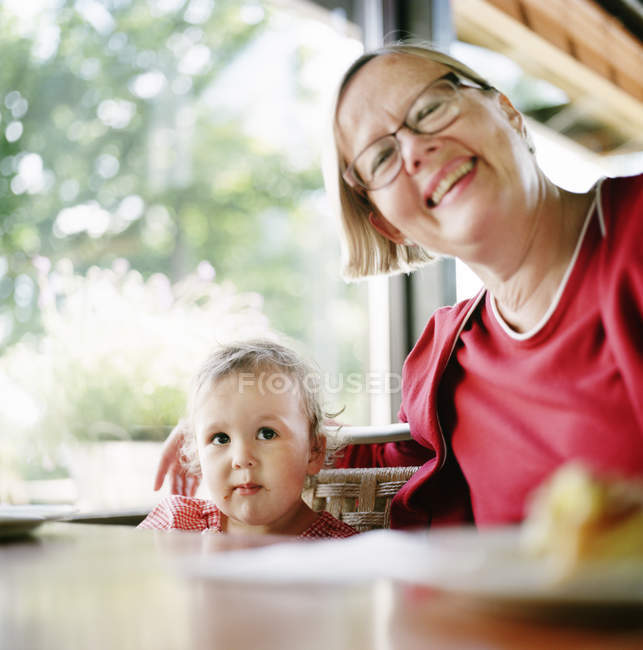 Portrait of grandmother with granddaughter, differential focus — Stock Photo