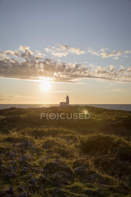 Front view of lighthouse against sunset sky — Stock Photo