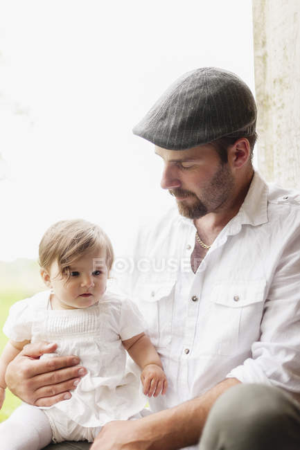 Portrait of man with baby girl, focus on foreground — Stock Photo