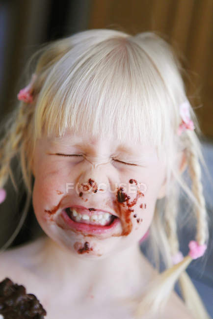 Portrait of girl with face dabbed with chocolate — Stock Photo