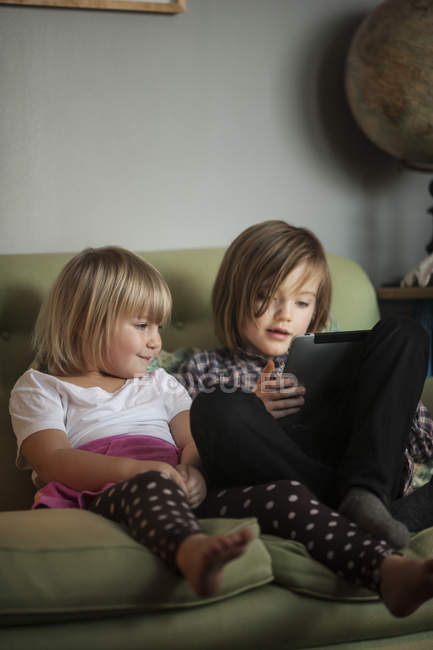 Girls using digital tablet, differential focus — Stock Photo