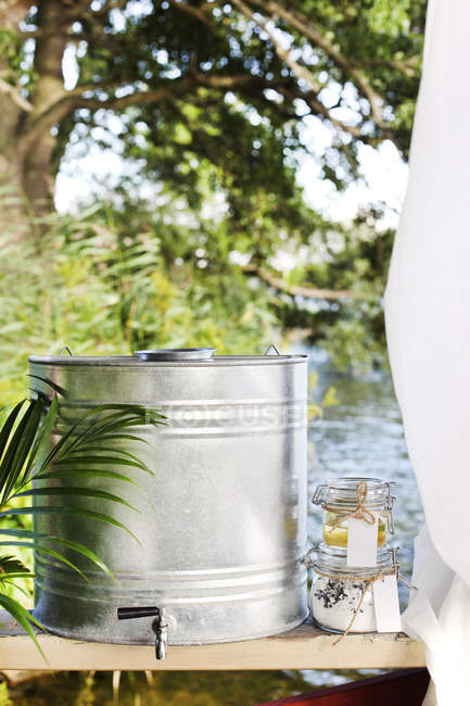 Metal barrel and jars outdoors at summer — Stock Photo