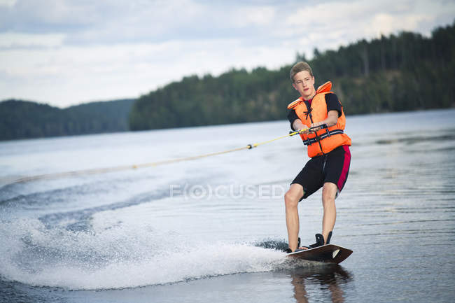 Teenage boy wakeboarding, selective focus — Stock Photo