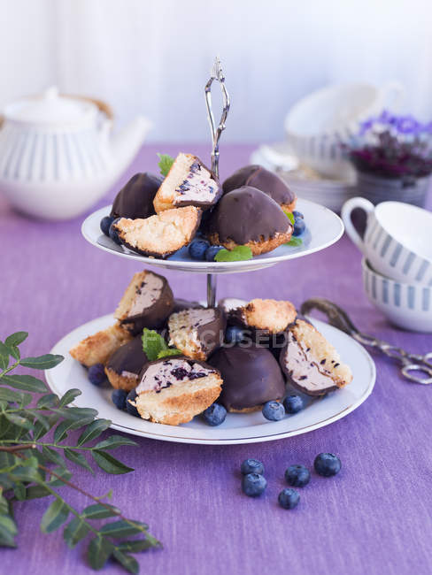 Bilberry pastries with cream on cakestand — Stock Photo