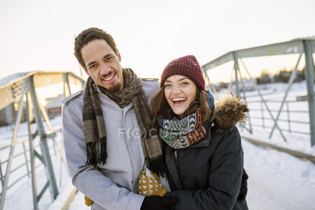 Young couple on footbridge at winter, focus on foreground — Stock Photo