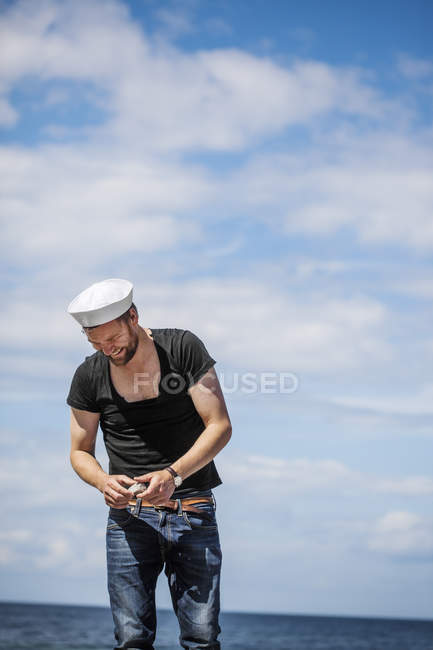 Smiling man against cloudy sky — Stock Photo