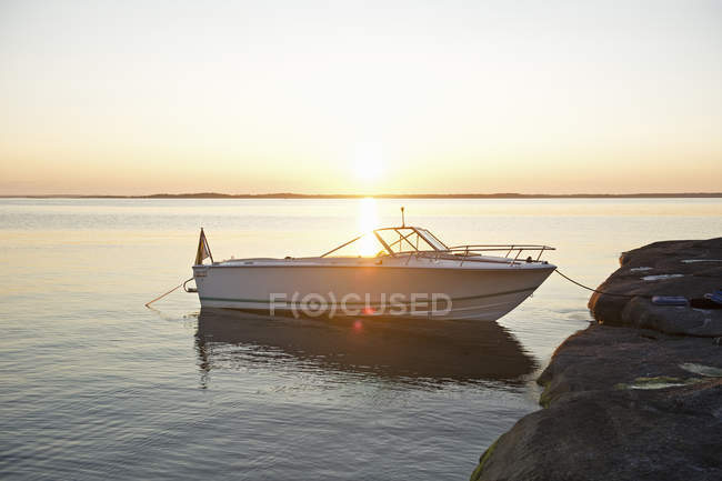 Scenic view of moored speedboat at sunset — Stock Photo