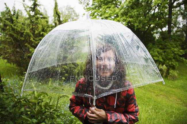 Portrait of woman wearing spotted raincoat — Stock Photo