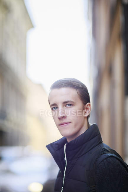 Portrait of young man in street, focus on foreground — Stock Photo