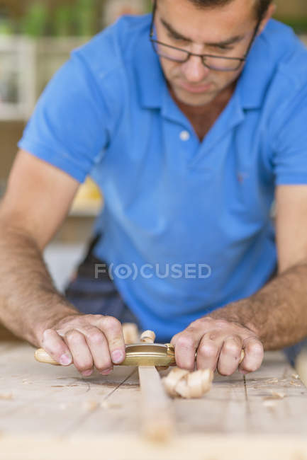 Carpenter planning wood, selective focus — Stock Photo