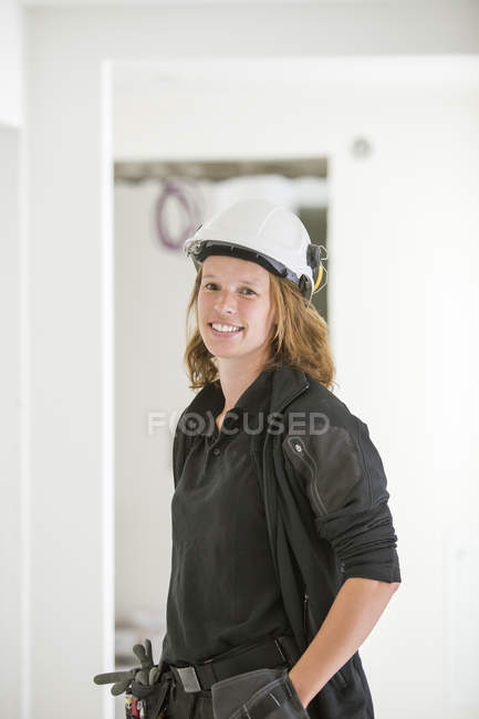 Woman in protective helmet, focus on foreground — Stock Photo