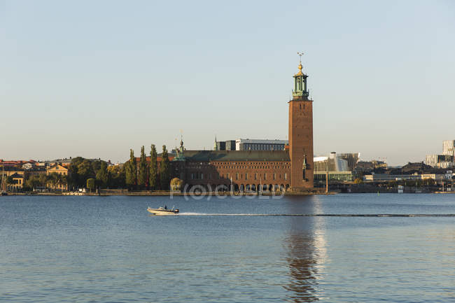 Stockholm Town hall with boat moving on water — Stock Photo