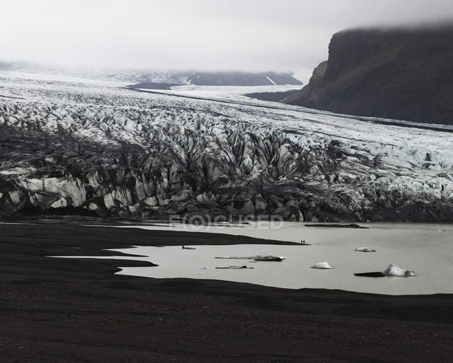 Glacier and rocks in fog, black and white — Stock Photo