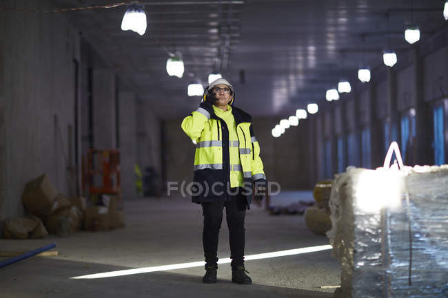 Woman in protective clothing using mobile phone — Stock Photo