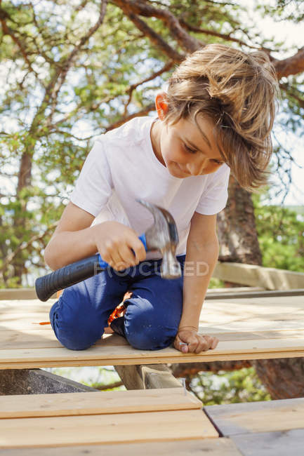Portrait of boy pounding hammer, selective focus — Stock Photo