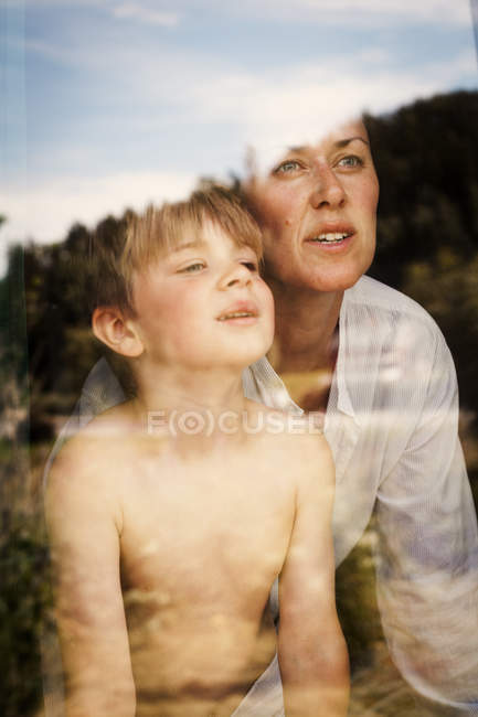 Mother and son peeking through window, selective focus — Stock Photo