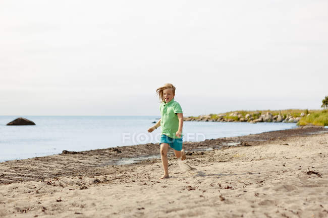 Девушка бегает по пляжу, избирательный фокус — стоковое фото