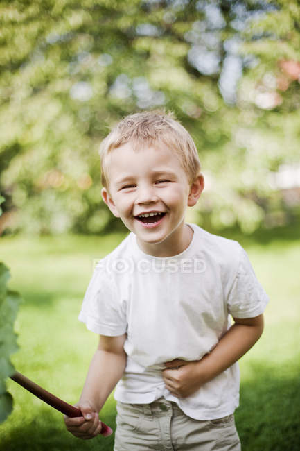Portrait of laughing boy, focus on foreground — Stock Photo
