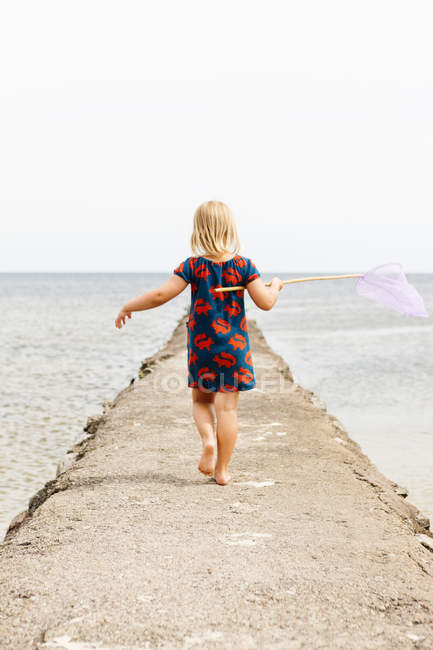 Rear view of girl holding fishing net, selective focus — Stock Photo